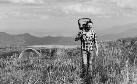 man with guitar in checkered shirtの写真素材
