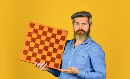 Enjoy tournament. Grandmaster player. Chess lesson. Cognitive development. Strategy concept. Chess competition. Board game. Thoughtful bearded man play chess. Chess figure. Intellectual gameの写真素材
