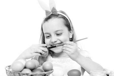 small happy baby girl with easter eggs isolated on whiteの写真素材