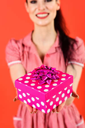 Portrait of a smiling cute woman opening gift box