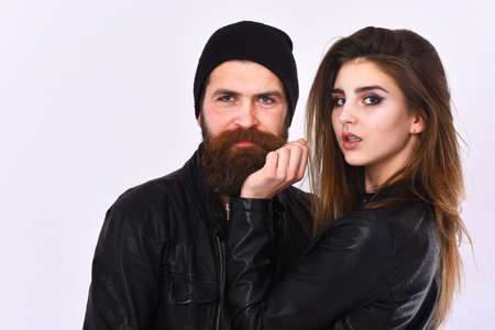 Girl and bearded man in black leather jacket and hat