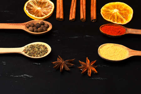 Composition of condiment, close up. Wooden spoons with spices