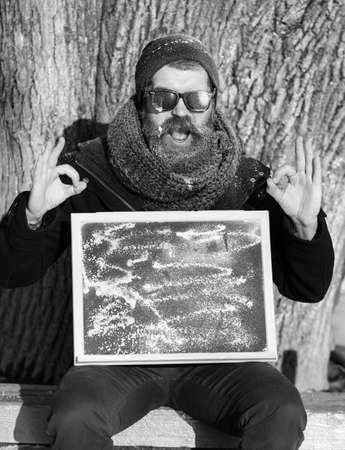 winter bearded man with board on natural background, copy spaceの写真素材