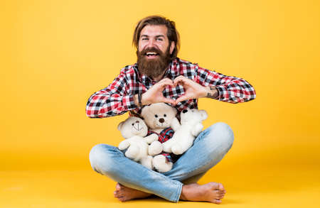 my heart is yours. Man with beard hold cute toy bear. Man holds teddy bear. Gifts and holidays concept. This is for you. hipster like animal toy. Birthday holiday party celebration. feel happinessの写真素材