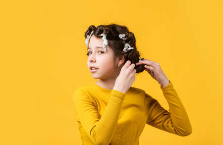 Fashion and beauty. Small girl hairdresser salon. Little child curly hair. Hairstyle concept....