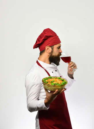 Sommelier and cooking service concept. Chef holds bowl with potatoの写真素材