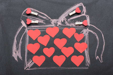 Present drawn on black board with pink chalkの写真素材