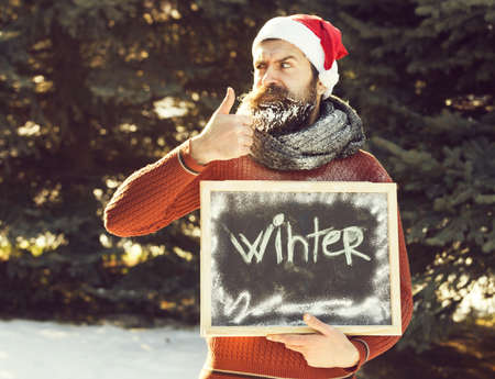 serious man santa with chalkboardの写真素材