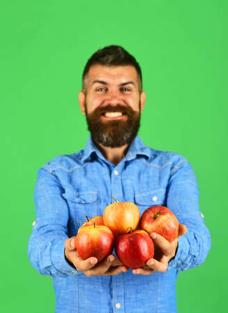Guy presents homegrown harvest. Farmer with smiling faceの写真素材