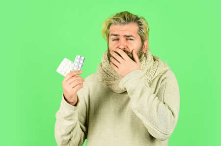 Sick man hold tablets. Virus pneumonia. Bearded hipster messy hairstyle. Buy medicines. Virus fever....