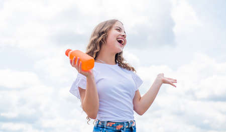 drinking natural juice in summer. portrait of pretty child girl. happy childhood. cheerful teen girl...