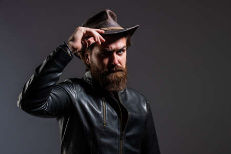 Brutal man cowboy hat leather jacket, masculinity concept