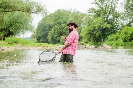 summer weekend. Big game fishing. bearded fisher in water. hobby and sport activity. pothunter....