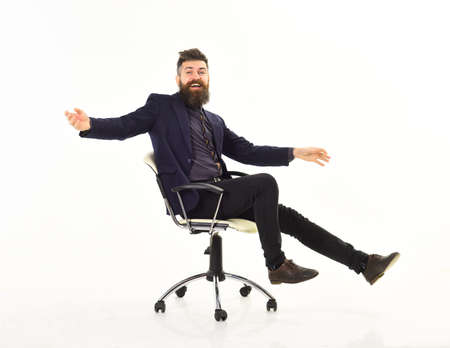 Businessman having fun. Cheerful businessman sitting on the office chairの写真素材