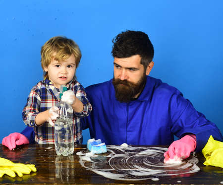 Guy with beard and mustache in gloves near cleaning props.の写真素材