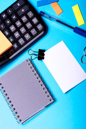 Bookmarks of different colors near grey notebook and penの写真素材