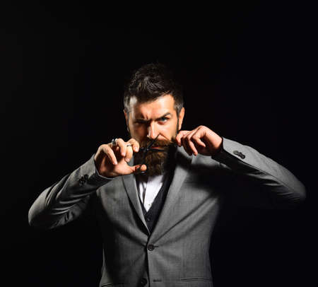 Bearded businessman having his mustache cut