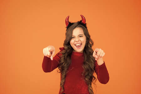 Party fun. she has bad character. autumn holiday celebration. small child red horns. cute imp. trick or treat. happy halloween. cheerful little girl halloween party. devil inside of meの写真素材