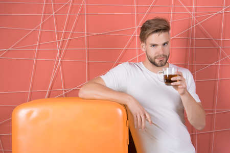 Health of man hold cup of tea or coffee at retro fridge on pink background. Health and healthy drink...