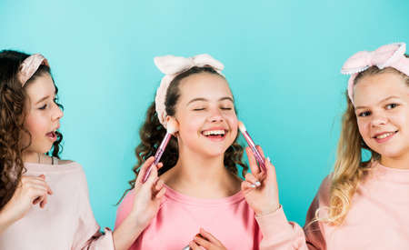 Happy girls doing makeup together. Sisterhood happiness. Skin care concept. Cosmetics for children....