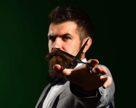 Businessman with confident face on dark green background