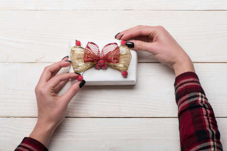 Holiday and surprise concept. Female hands hold box