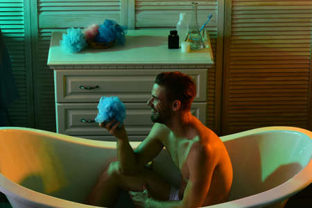 Man with beard and happy face in bathtubの写真素材