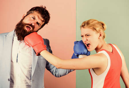 Couple in love competing in boxing. Conflict concept. Gender battle. Gender equal rights. Family quarrel. Boxers fighting in gloves. Domination concept. Gender equality. Man and woman boxing fightの写真素材