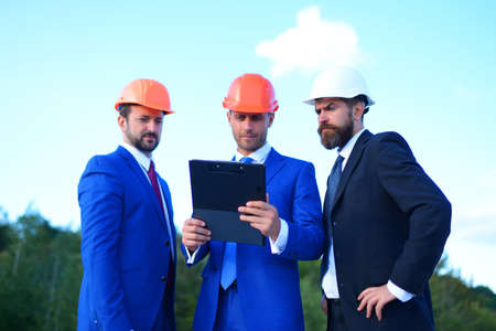 Board of architects with confident faces in suits and helmetsの写真素材
