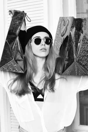 pretty sexy woman in sunglasses with colorful present packageの写真素材