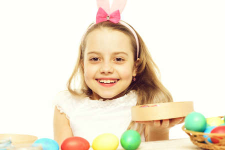 small happy baby girl with easter eggs isolated on white