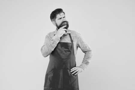 Inspired for changes. Man brutal bearded hipster with mustache wear apron. Barbershop staff. Beard grooming salon. Well groomed macho barber. Hipster style. Barbershop concept. Hairdresser barberの写真素材