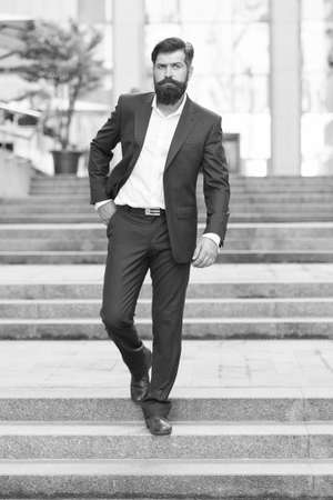 Business people. On his way to success. Walking down street. Mature hipster with beard on stairs. Bearded man in business centre. Confident brutal man walk street. Businessman in formal clothesの写真素材