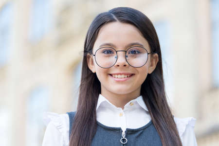 Happy child wear round-framed eye glasses and formal fashion uniform knowledge day, look. school...