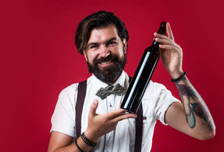 Man in suspenders and bow tie choosing a wine bottle, best quality