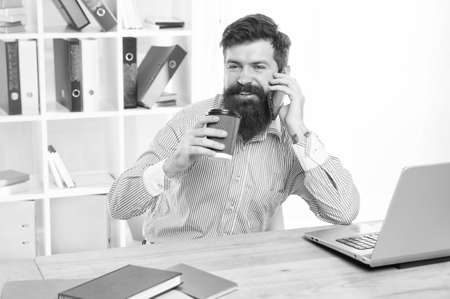 Sales and marketing. Marketing manager talk on phone drinking coffee in office. Digital advertising...