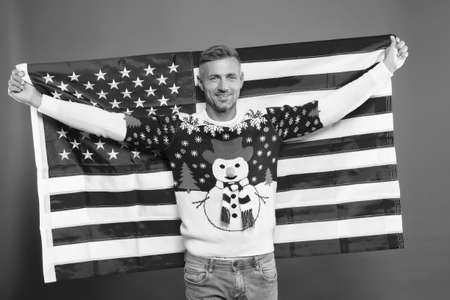 Freedom forever. Handsome man celebrate winter holidays red background. Guy wear winter sweater....