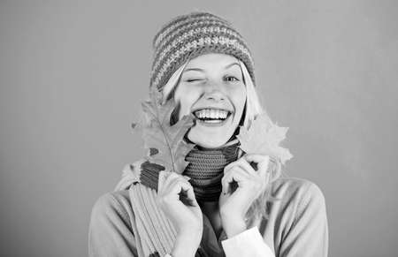 Healthy skin. Skincare and beauty tips. Woman cute face wear knitted hat hold fallen leaves. Time to...