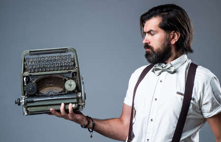 Professional reporter working on vintage typewriter, old technology conceptの写真素材