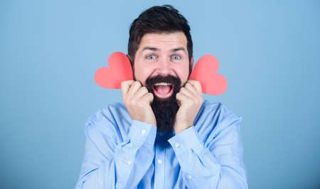 Loving you is what I do. Sexy valentine man with heart shaped cards. Bearded man holding red hearts. Hipster with small hearts. Happy valentines day. Expressing his loveの写真素材