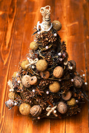Fir tree decorated with nuts, dry anise and acorns.