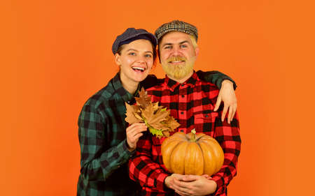 Work at fields. Harvest festival. Farmers market. Autumn mood. Couple in love checkered rustic outfit. Retro style. Fall season. Autumn leaves. Farmer family concept. Autumn harvesting worksの写真素材