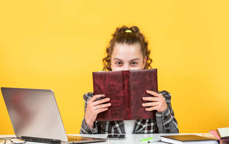 Teen girl study at home. Education course. Information to learn. Modern school. Homeschooling concept. Communication social networks. Distance learning. Pupil with book. Smart student. Self educationの写真素材