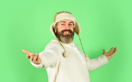 Facial hair concept. Fur garments. Bearded hipster. Hairdresser salon. Barber services. Bearded man wear hat with ear flaps. Furry accessory. Winter fashion. Cold weather. Beard care winter seasonの写真素材