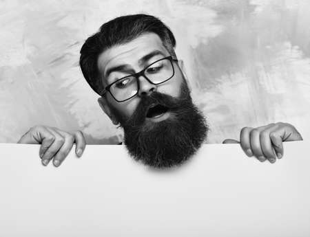 bearded man with surprised face in glasses on colorful backgroundの写真素材
