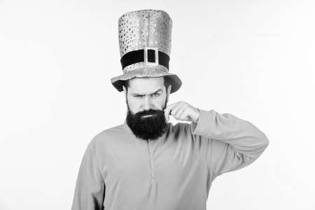 Look at my moustache. Bearded man celebrating saint patricks day. Hipster in leprechaun hat and costume twirling moustache. Happy saint patricks day. Irish man with beard wearing greenの写真素材