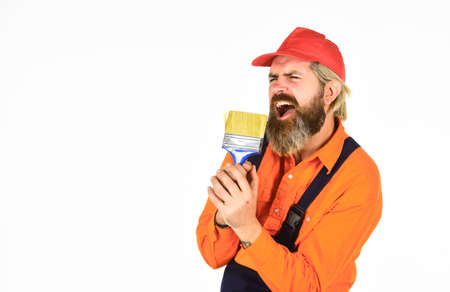 Talented master. Priming entire wall. Bearded mature man painter. Wall painter with painting tool. Hipster painter. Painters work. Construction and renovation. Decoration and decor. Painting wallsの写真素材