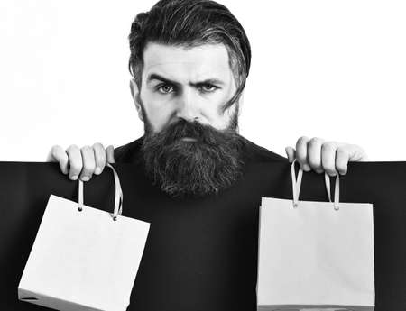 Bearded brutal caucasian hipster holding colorful package or bagsの写真素材
