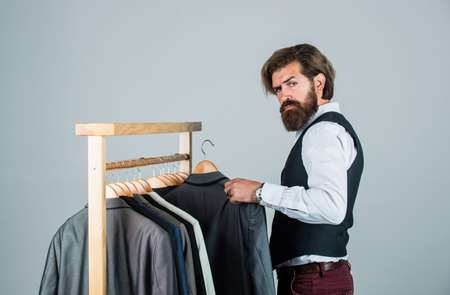 Man ordering business suit posing indoor. Tailor measures man. stylish man at workspace. Fashion design studio. Male fashion designer. Individual measures hand of man. Good feedback from clientの写真素材