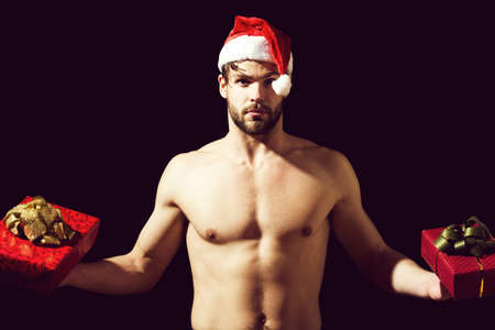 santa muscular man with present boxesの写真素材